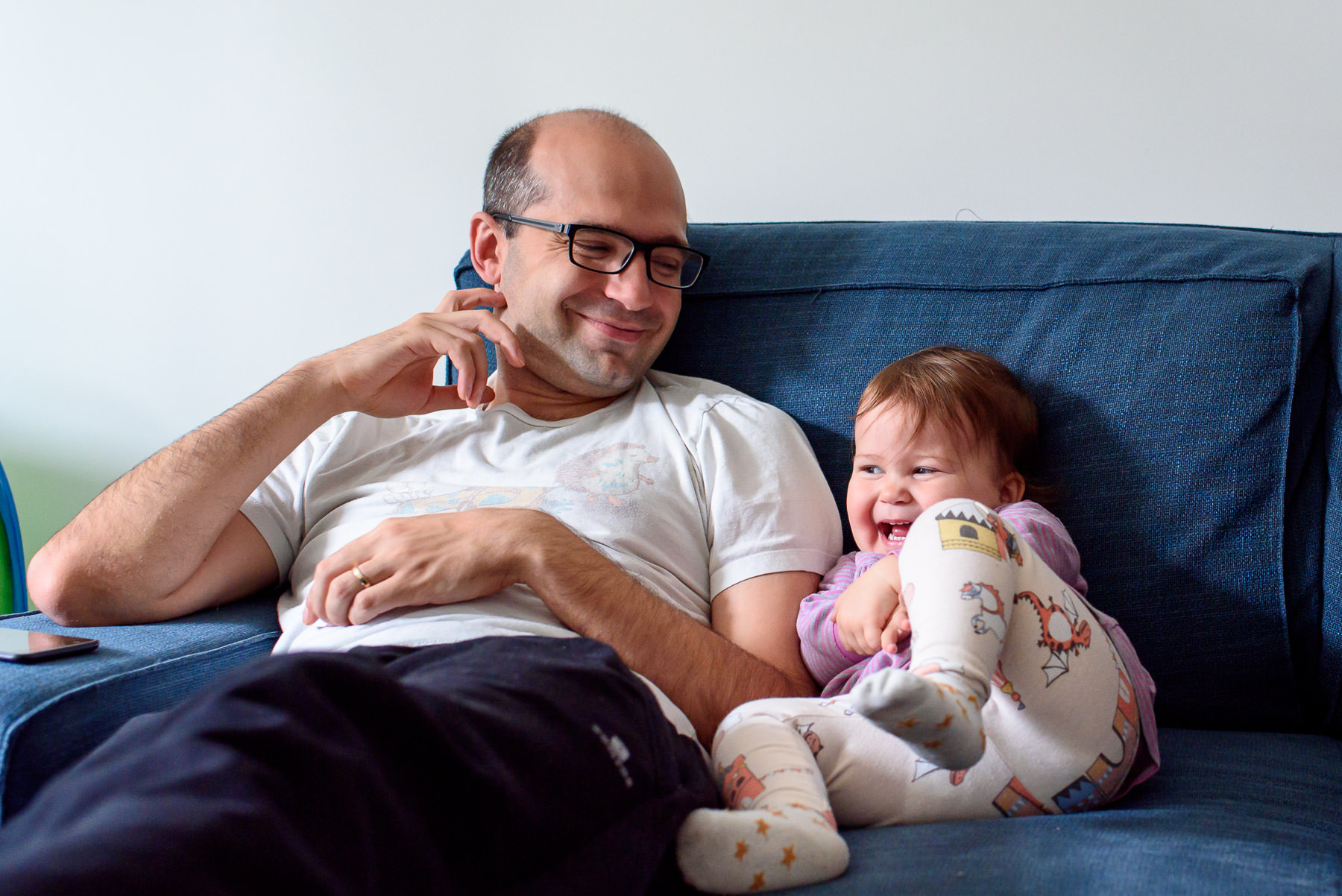 dad and little girl smiling on the couch